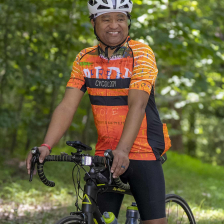 Terry Woodyard smiles while standing with his bike
