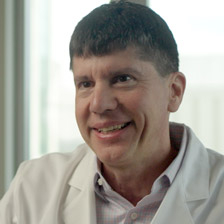The doctor smiles at the camera