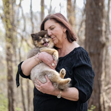 Juli hugs her dog close to her face