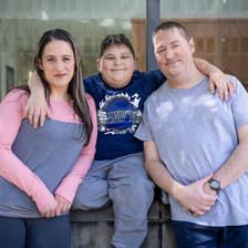 Arielle, Garin, and Nick Lege stand on Duke University Hospital's campus. Nick Lege received a liver and heart transplant at Duke.