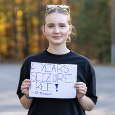 Camila holds up a sign saying "2 years seizure free!"