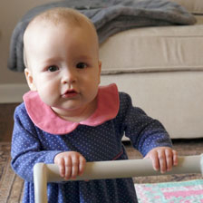 Grace Ray holds her walker and looks at the camera